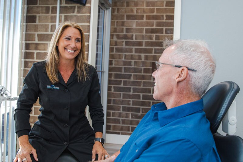 coordinator with patient discussing treatment