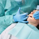 Woman receiving dental sedation in dentist office