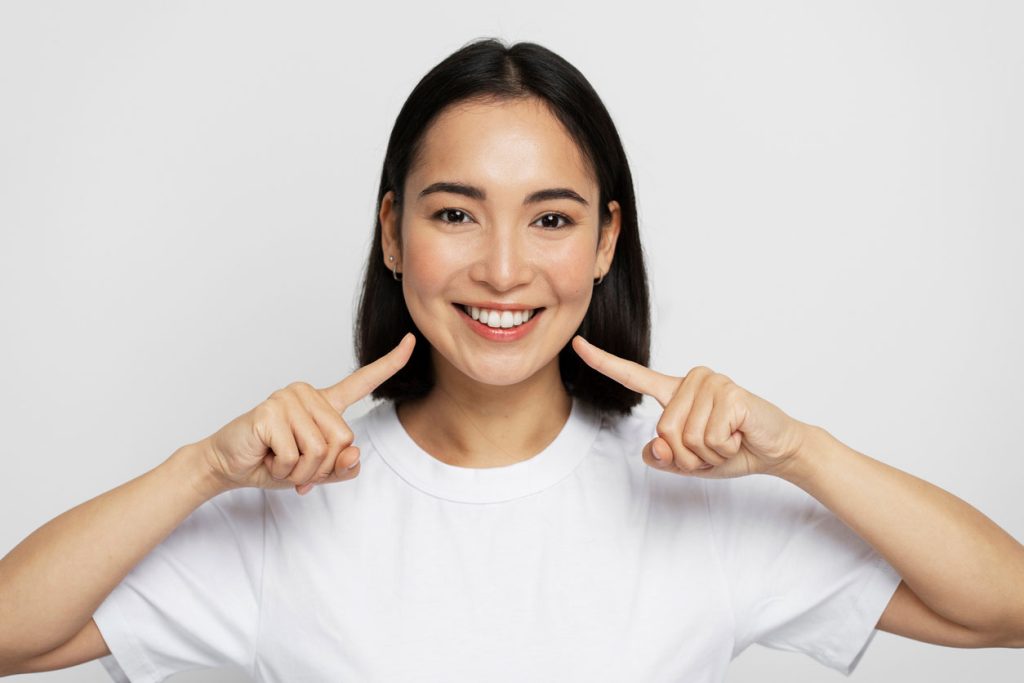 woman shows her white teeth